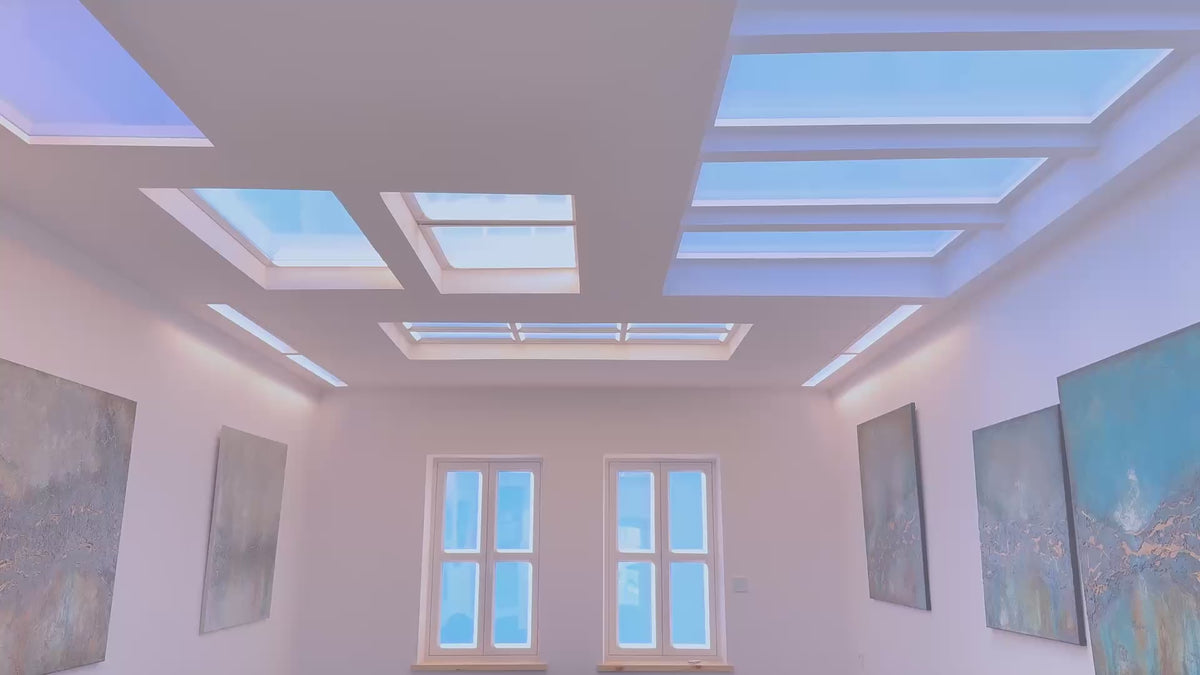 Inside the Polightme showroom in Warsaw: artificial skylights and blue-sky window lamps above paintings.